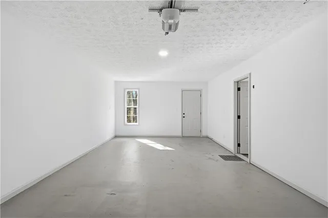 an empty room with a empty space and windows