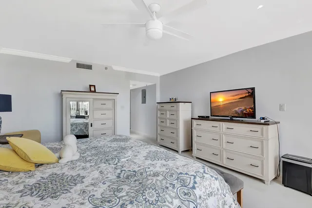 a bedroom with a bed and a television