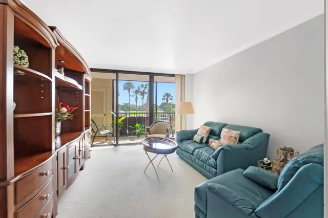 a living room with furniture cabinets and a window