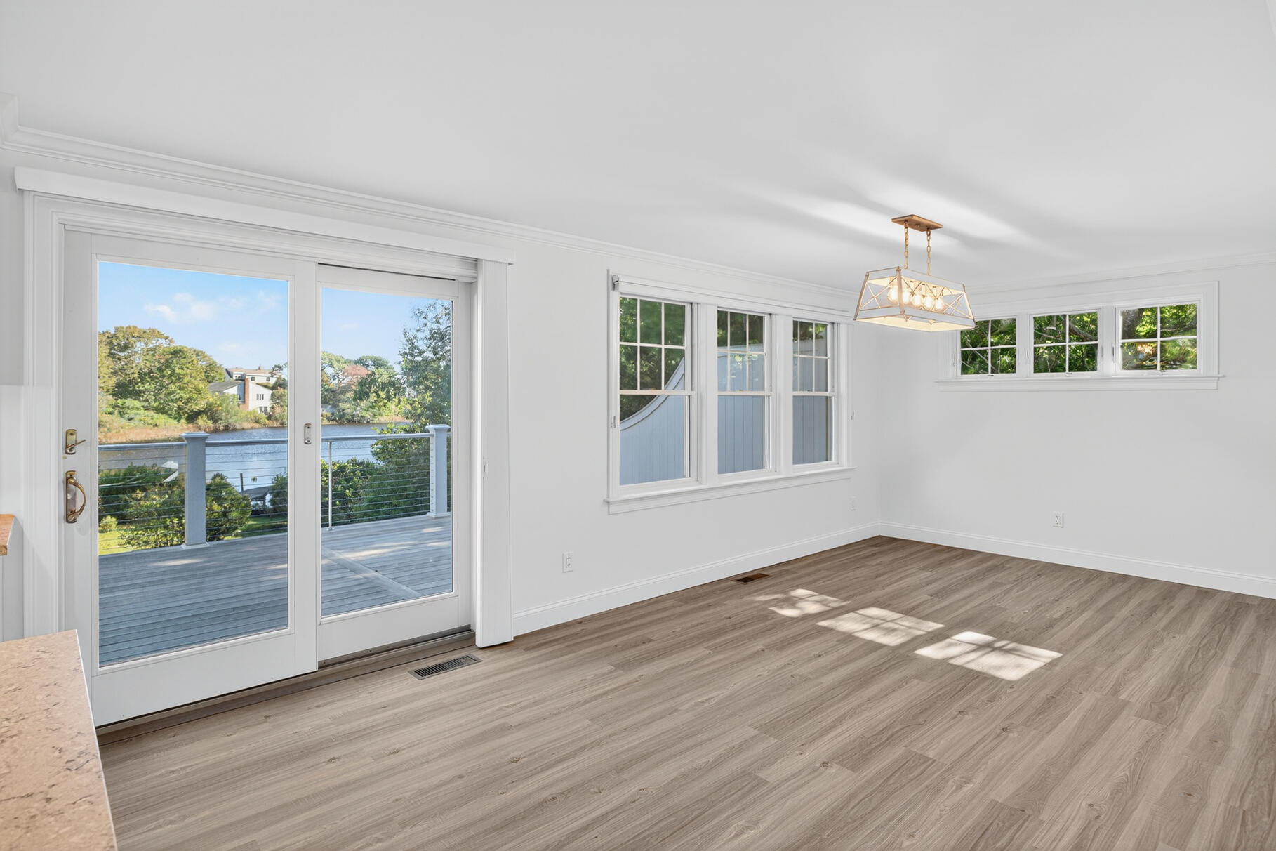 128 Uncle Percy's Road Mashpee, MA 02649 - Photo 14 of 45 a view of an empty room with wooden floor and a window