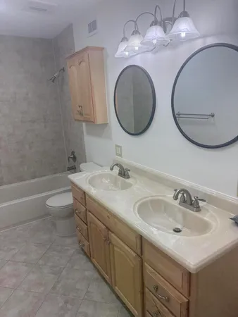 a bathroom with a double vanity sink and a mirror