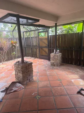 a backyard of a house with table and chairs