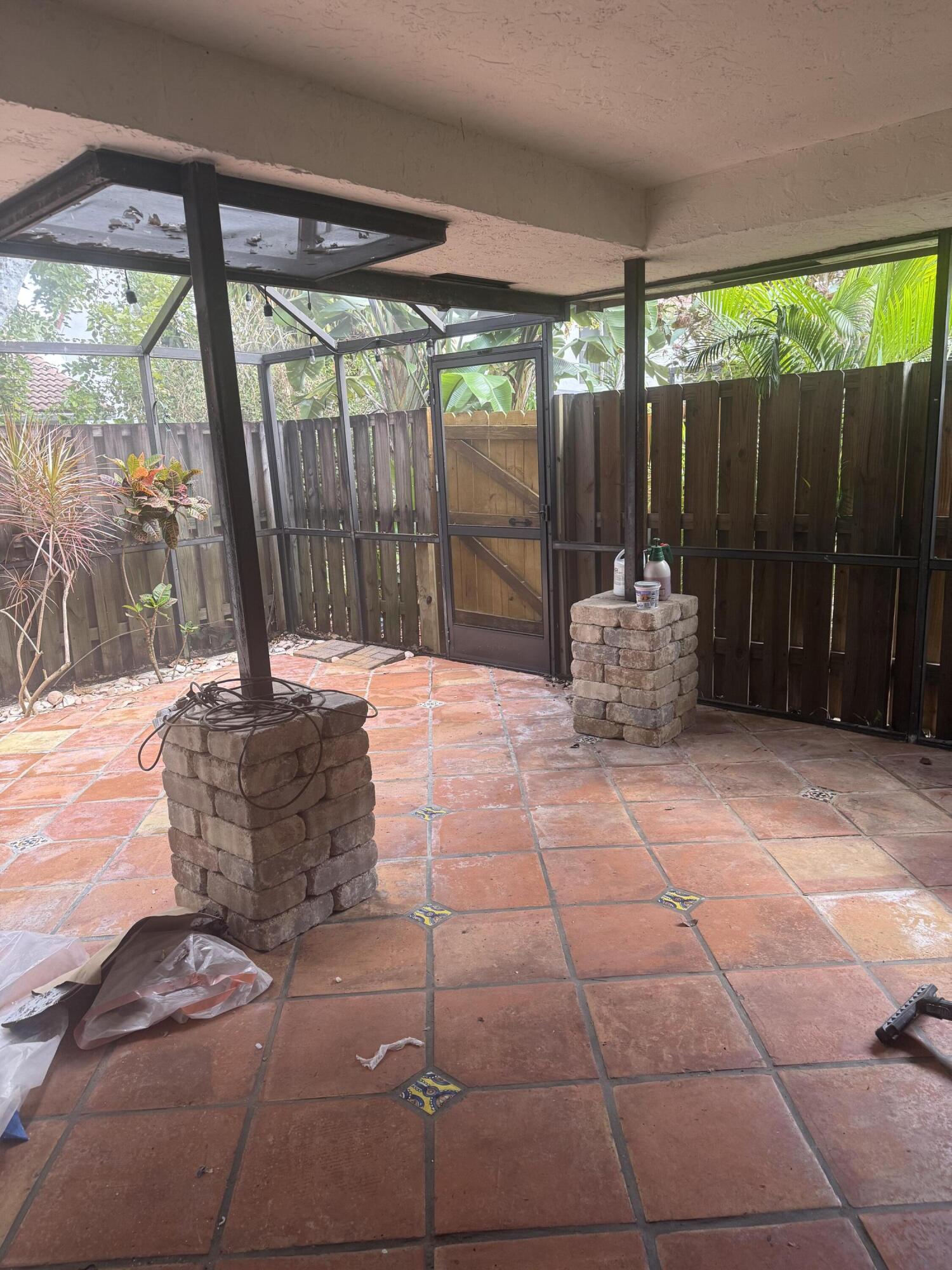 7526 Courtyard Run East Boca Raton, FL 33433 - Photo 16 of 16 a backyard of a house with table and chairs