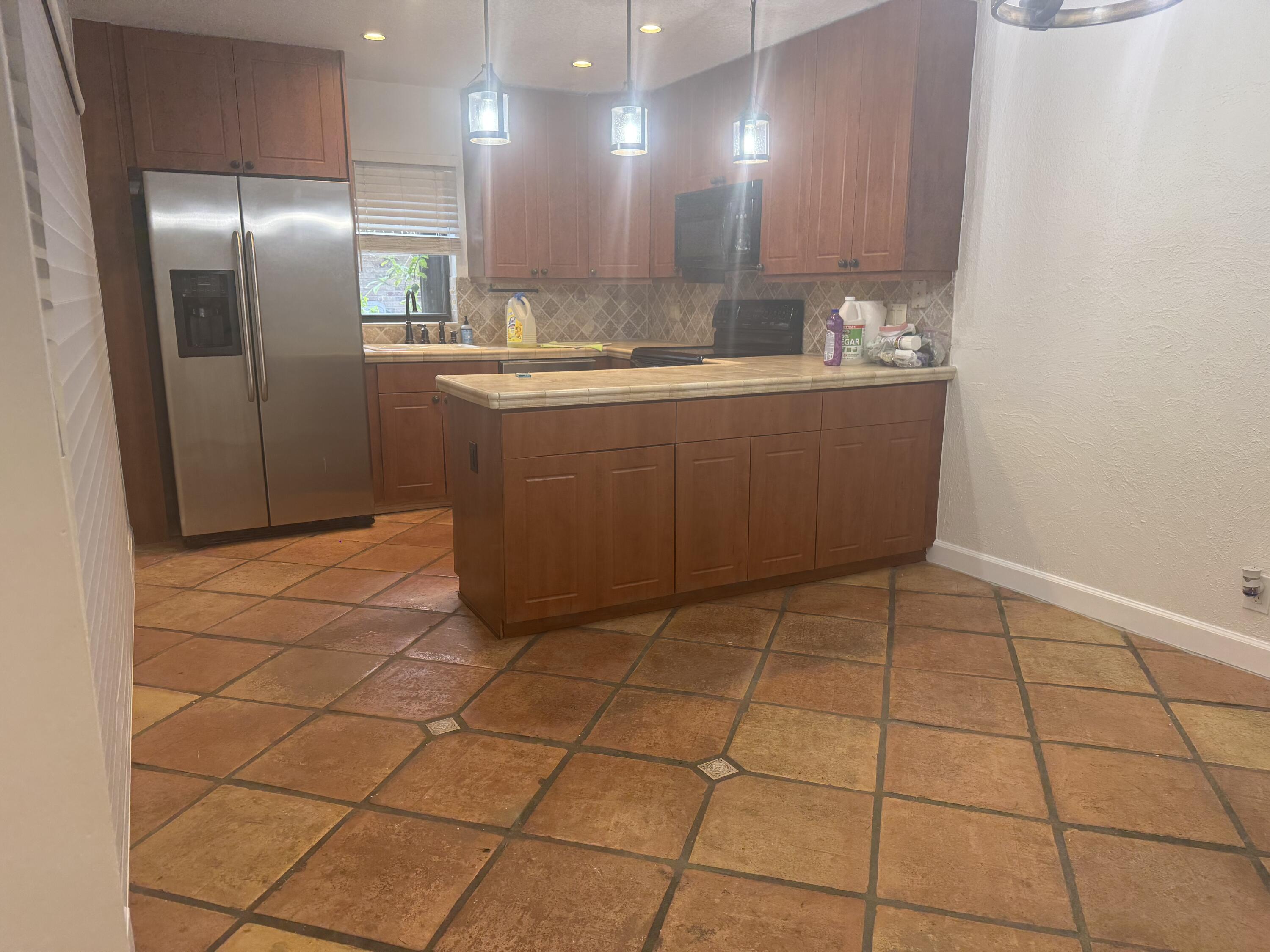 7526 Courtyard Run East Boca Raton, FL 33433 - Photo 4 of 16 a kitchen with stainless steel appliances a sink a refrigerator and a mirror