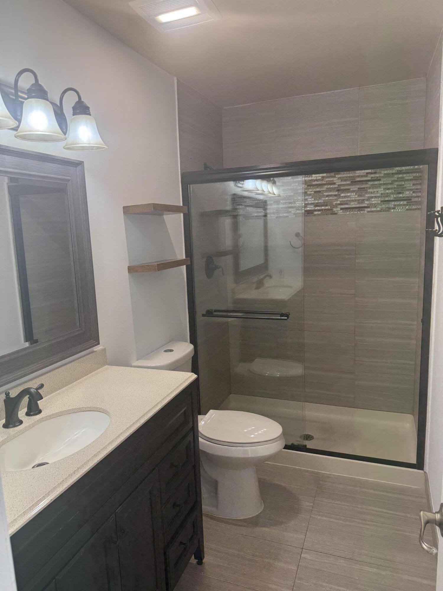 7526 Courtyard Run East Boca Raton, FL 33433 - Photo 6 of 16 a bathroom with a sink a toilet and shower