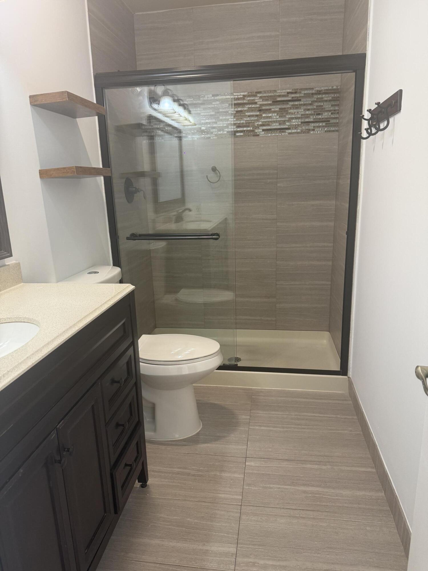 7526 Courtyard Run East Boca Raton, FL 33433 - Photo 7 of 16 a bathroom with a shower a toilet and a sink