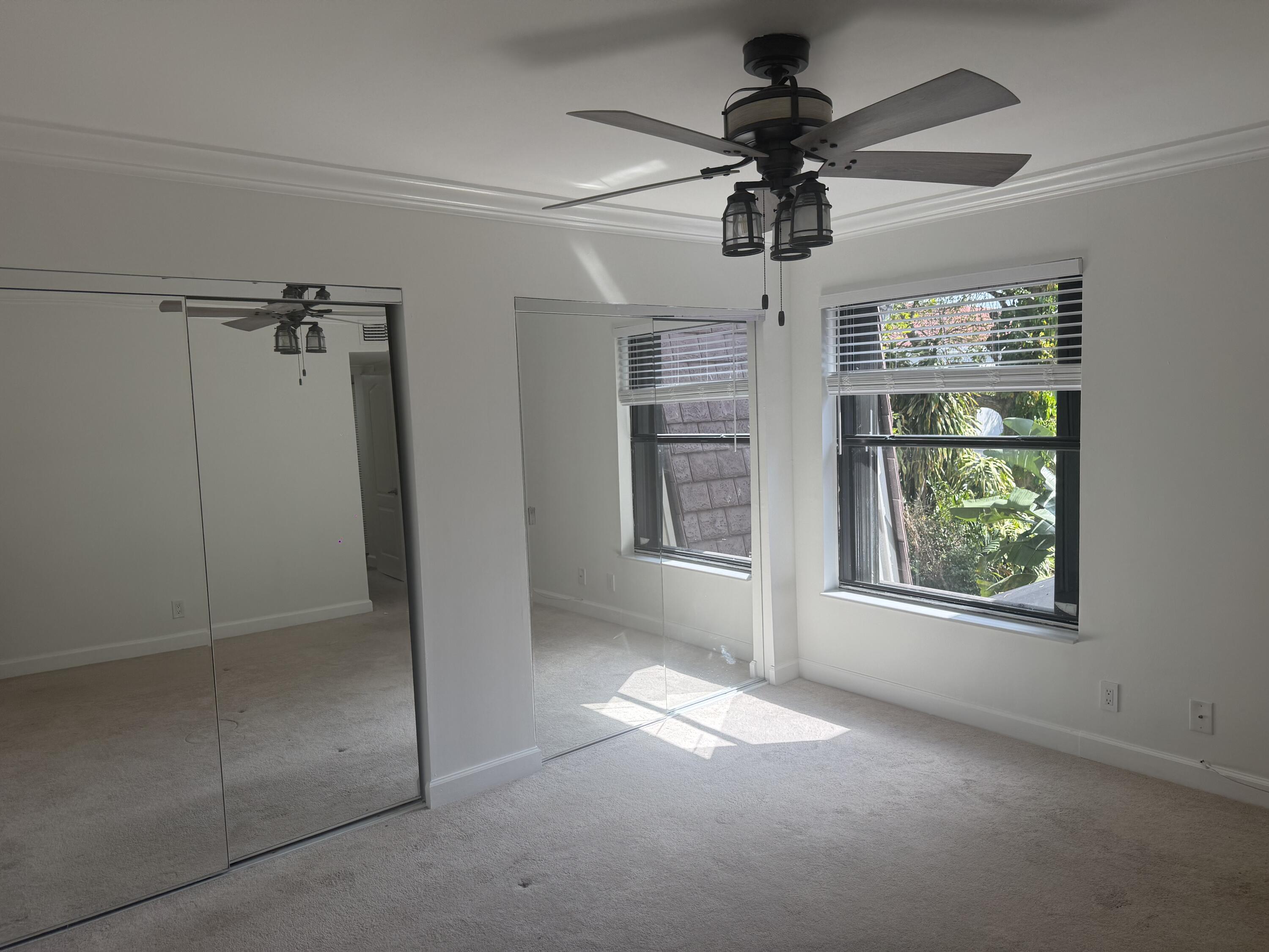 7526 Courtyard Run East Boca Raton, FL 33433 - Photo 10 of 16 wooden floor in an empty room with a window