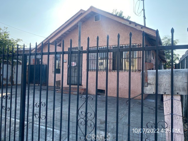 a front view of a house with a iron gate