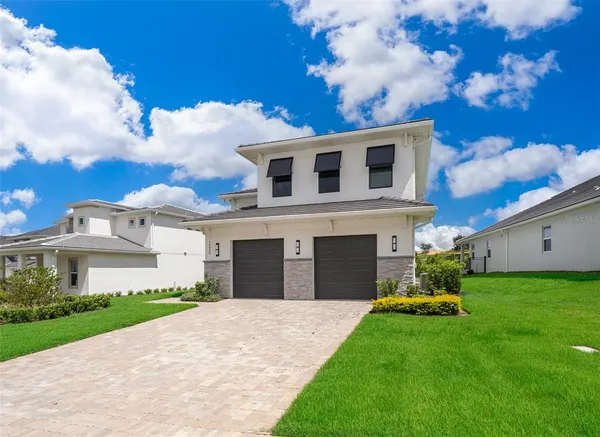a front view of a house with a garden and yard