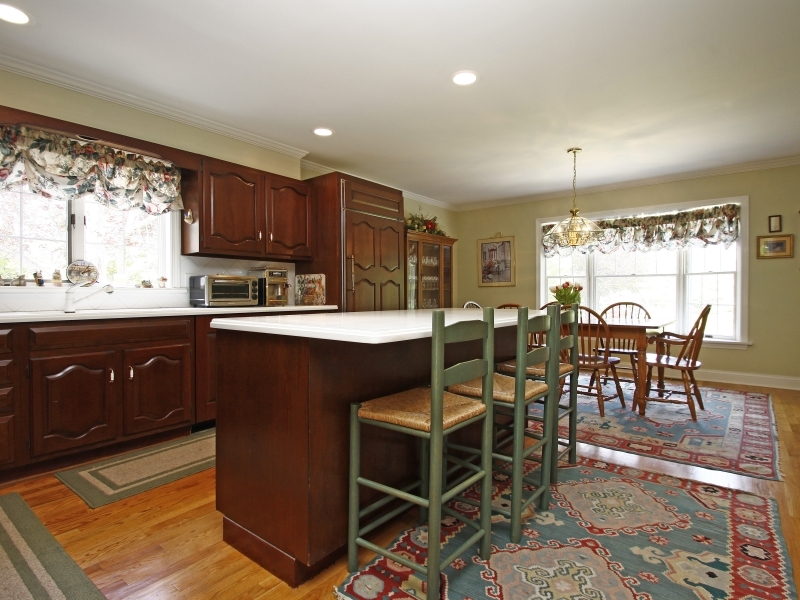 29 Middle Ridge Road New Canaan, CT 06840 - Photo 5 of 16 a kitchen with stainless steel appliances granite countertop a table chairs sink and cabinets
