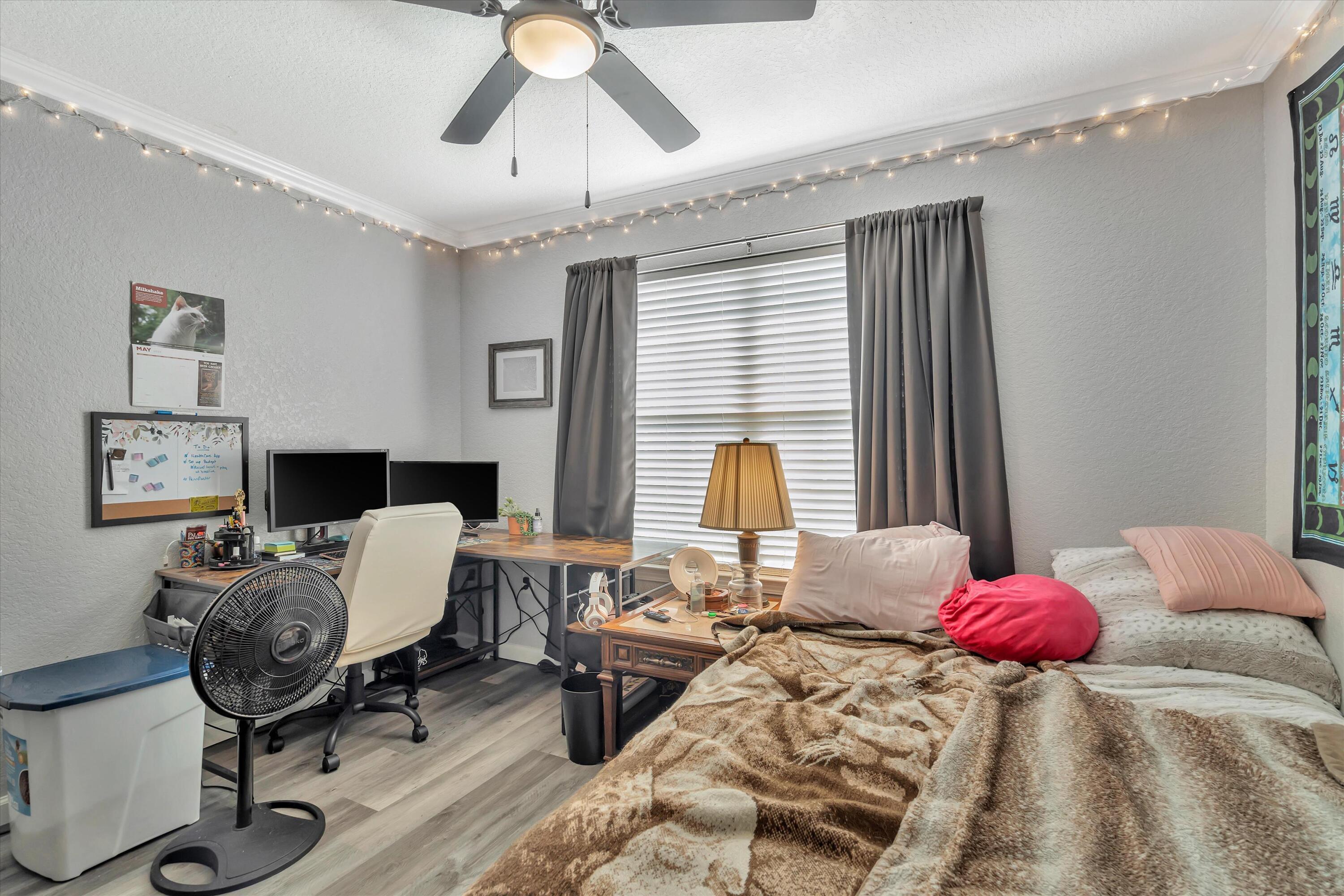 266 Limestone Circle Crestview, FL 32539 - Photo 14 of 25 a bedroom with a bed and wooden floor