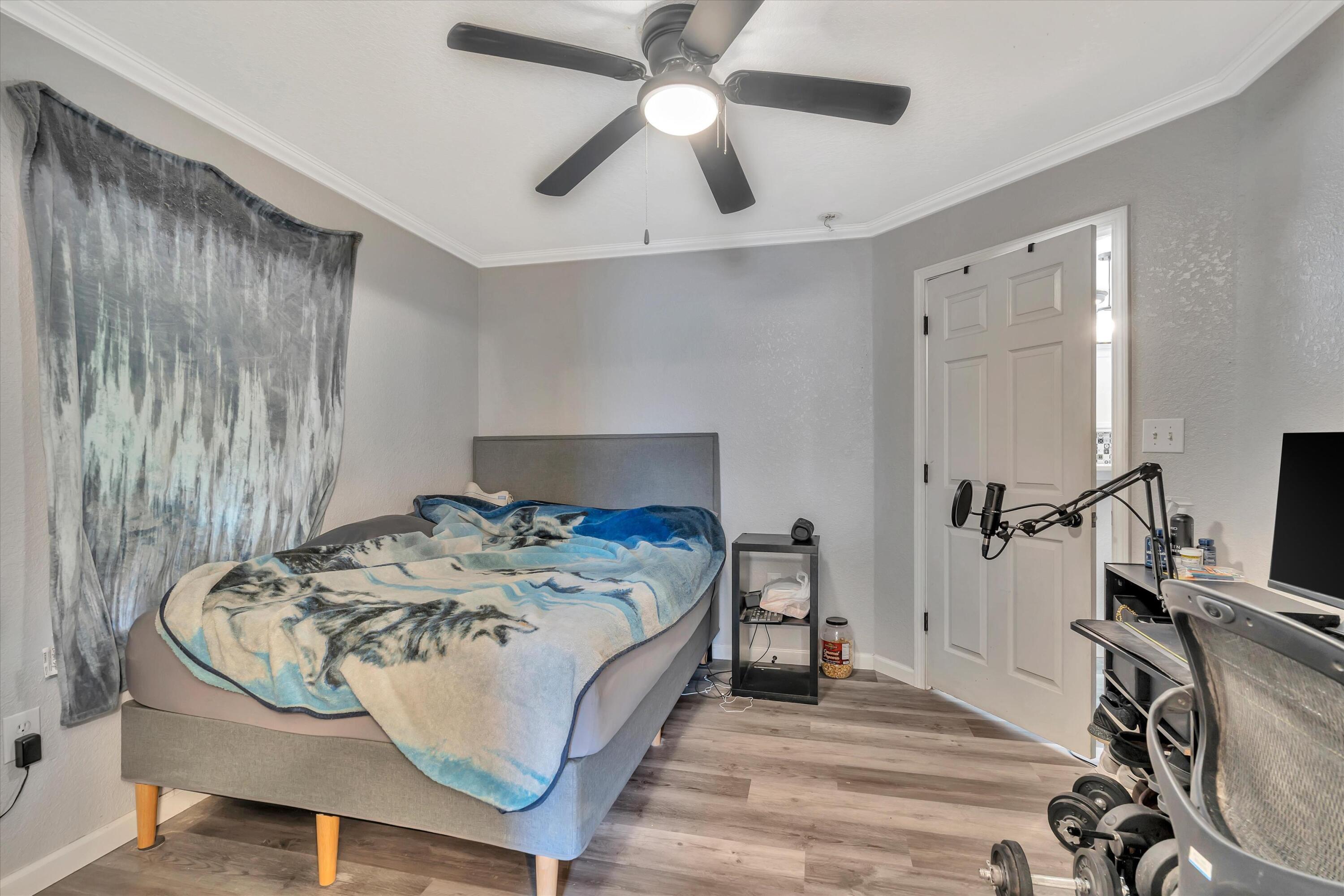 266 Limestone Circle Crestview, FL 32539 - Photo 16 of 25 a bed sitting in a bedroom next to a window with pc on the table