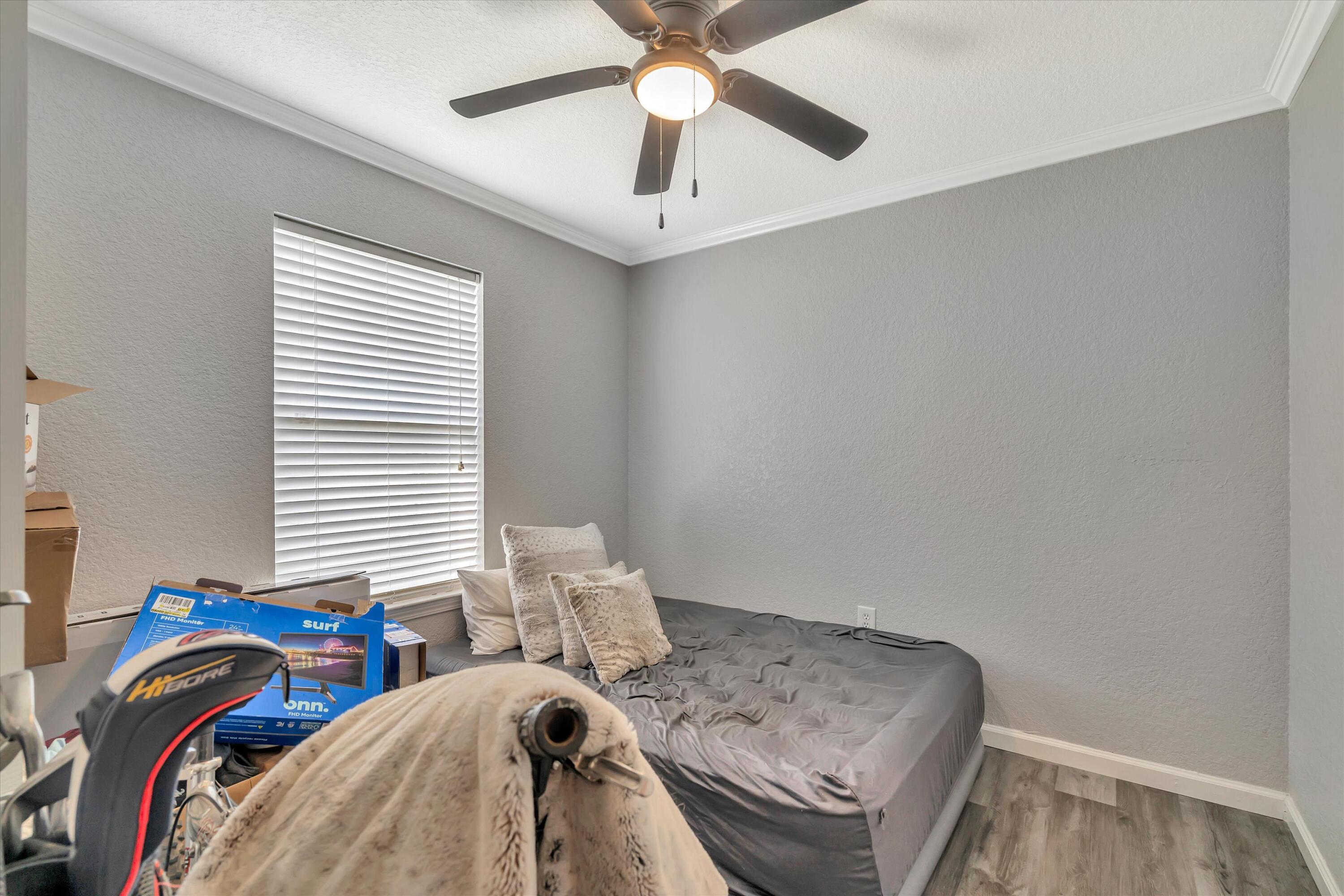 266 Limestone Circle Crestview, FL 32539 - Photo 17 of 25 a bedroom with a bed and a chandelier
