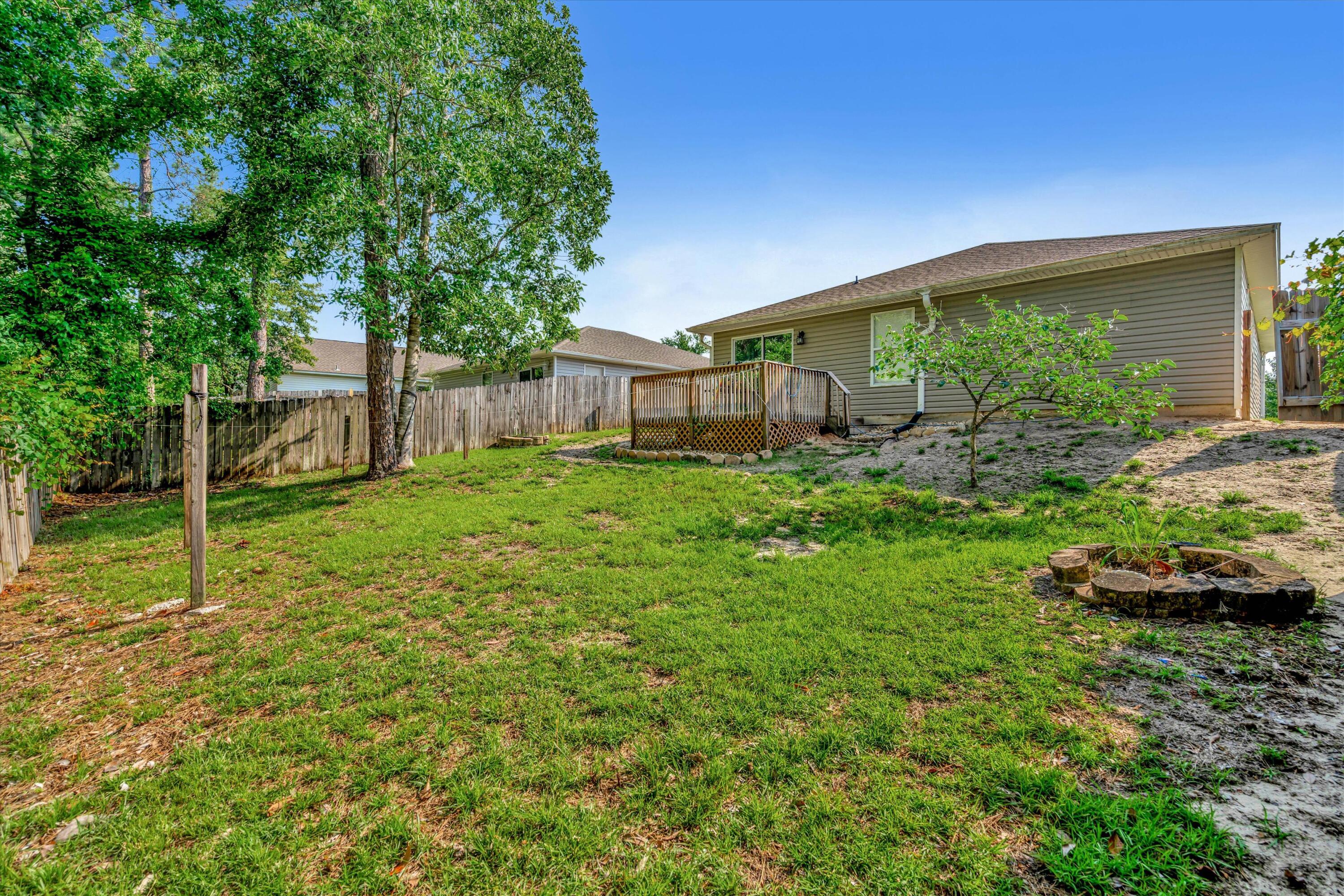 266 Limestone Circle Crestview, FL 32539 - Photo 25 of 25 a backyard of a house with lots of green space