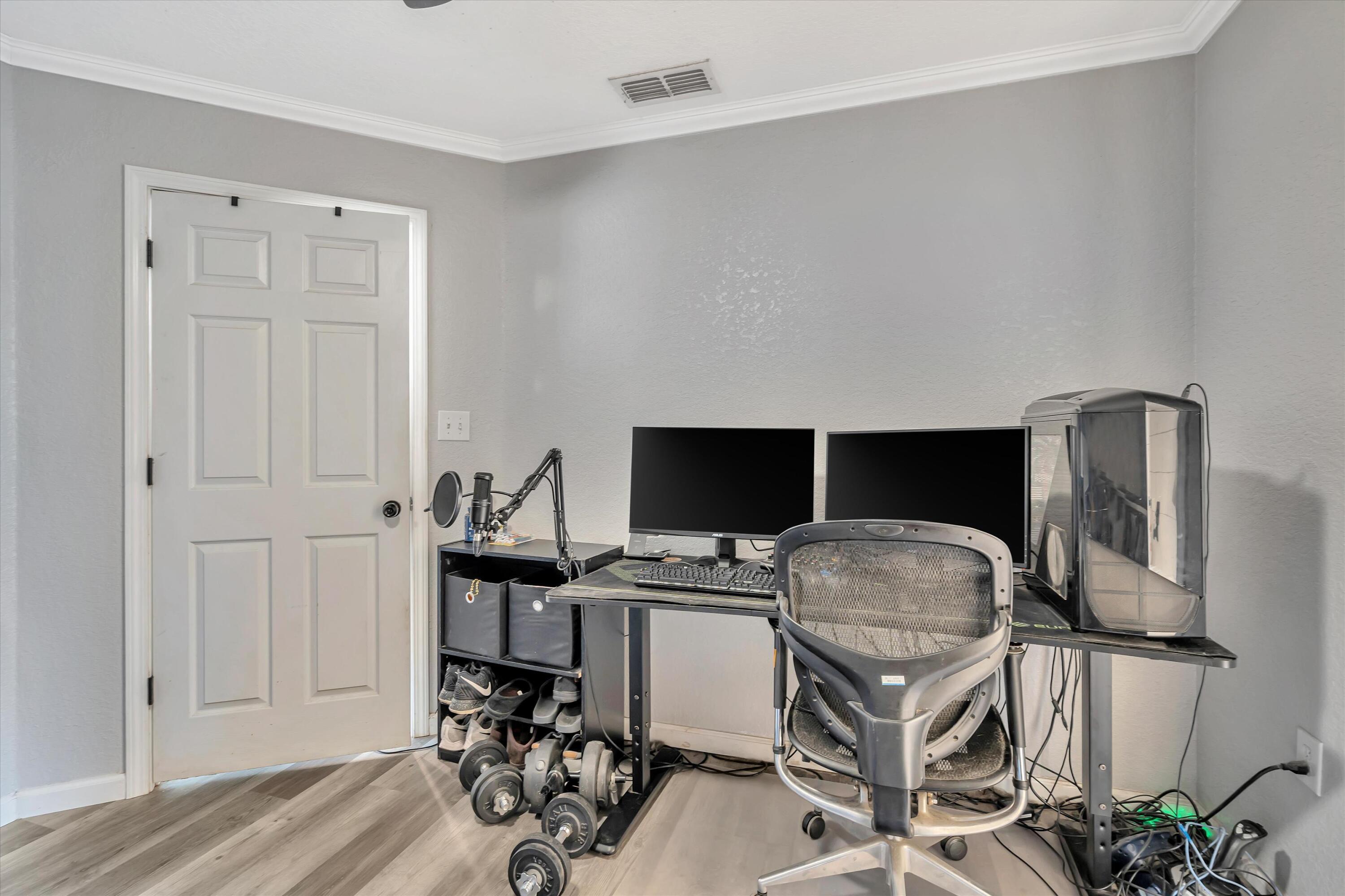 266 Limestone Circle Crestview, FL 32539 - Photo 10 of 25 a workspace with furniture and wooden floor