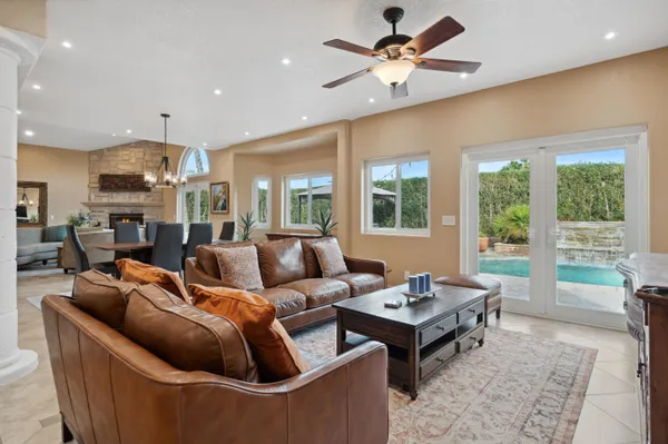 a living room with furniture a table and a large window