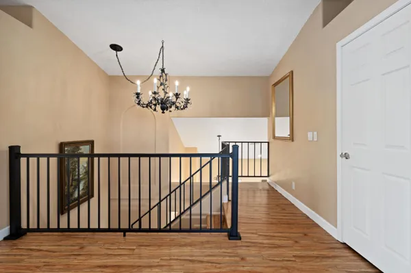 a view of a balcony with furniture and wooden floor