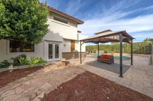 a view of a house with backyard and sitting area