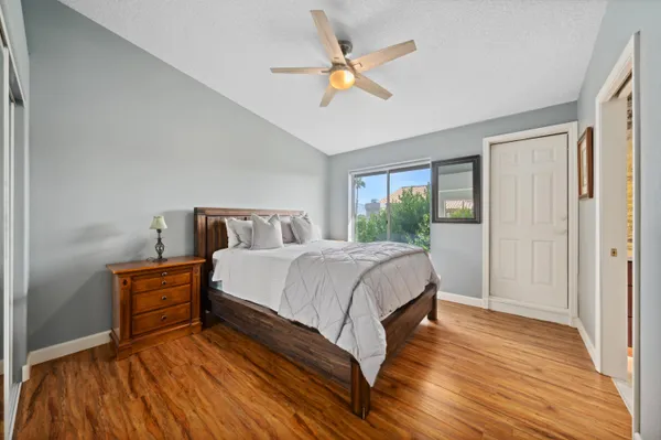 a bedroom with a bed and a ceiling fan