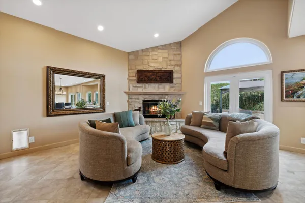 a living room with furniture a fireplace and a flat screen tv
