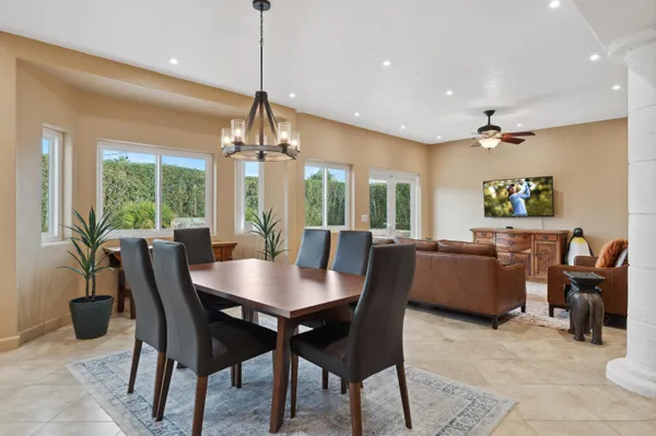 a dining room with furniture a window and a chandelier