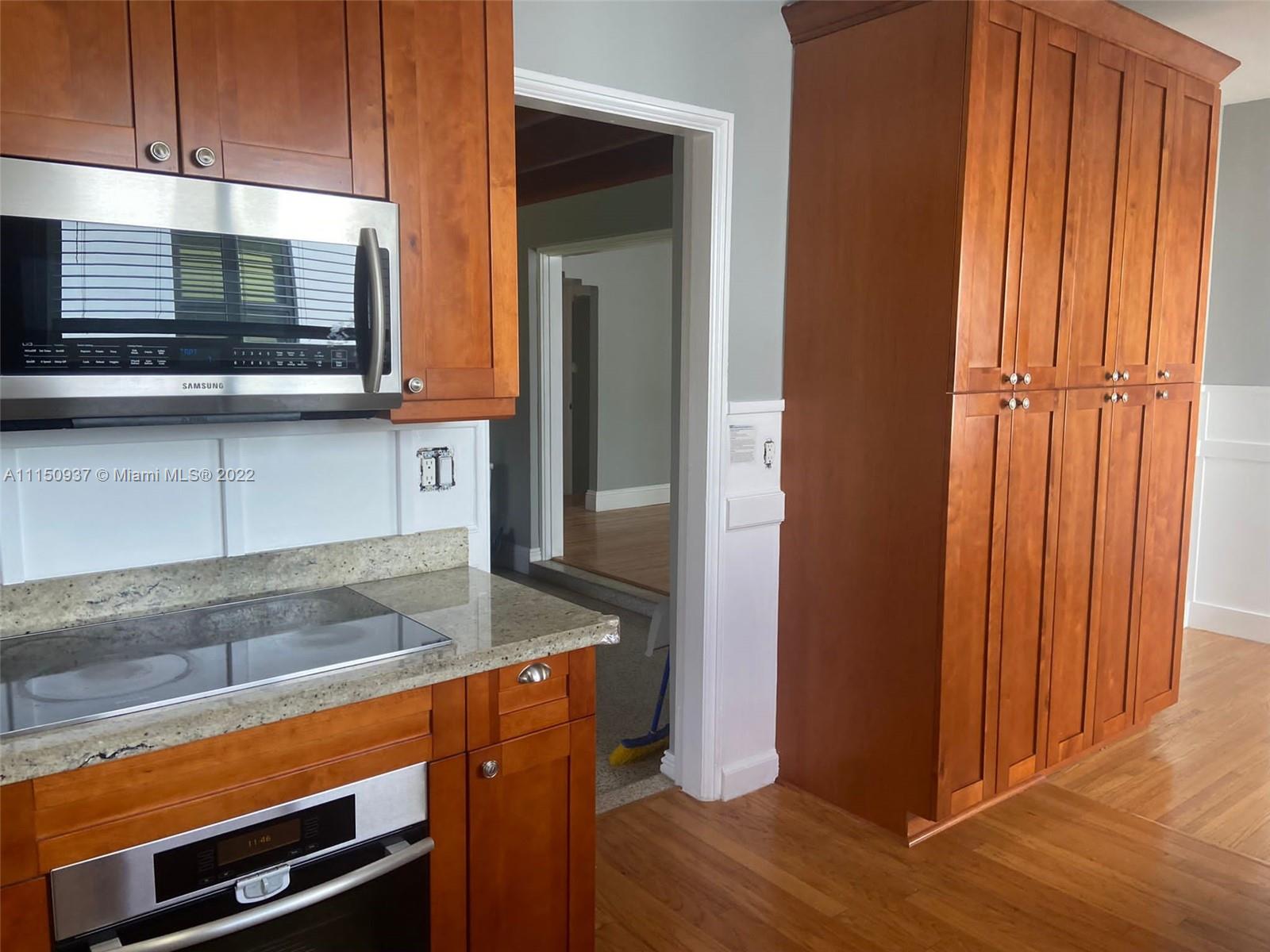 155 Southwest 28th Road Miami, FL 33129 - Photo 12 of 33 a kitchen with stainless steel appliances granite countertop a refrigerator and a microwave
