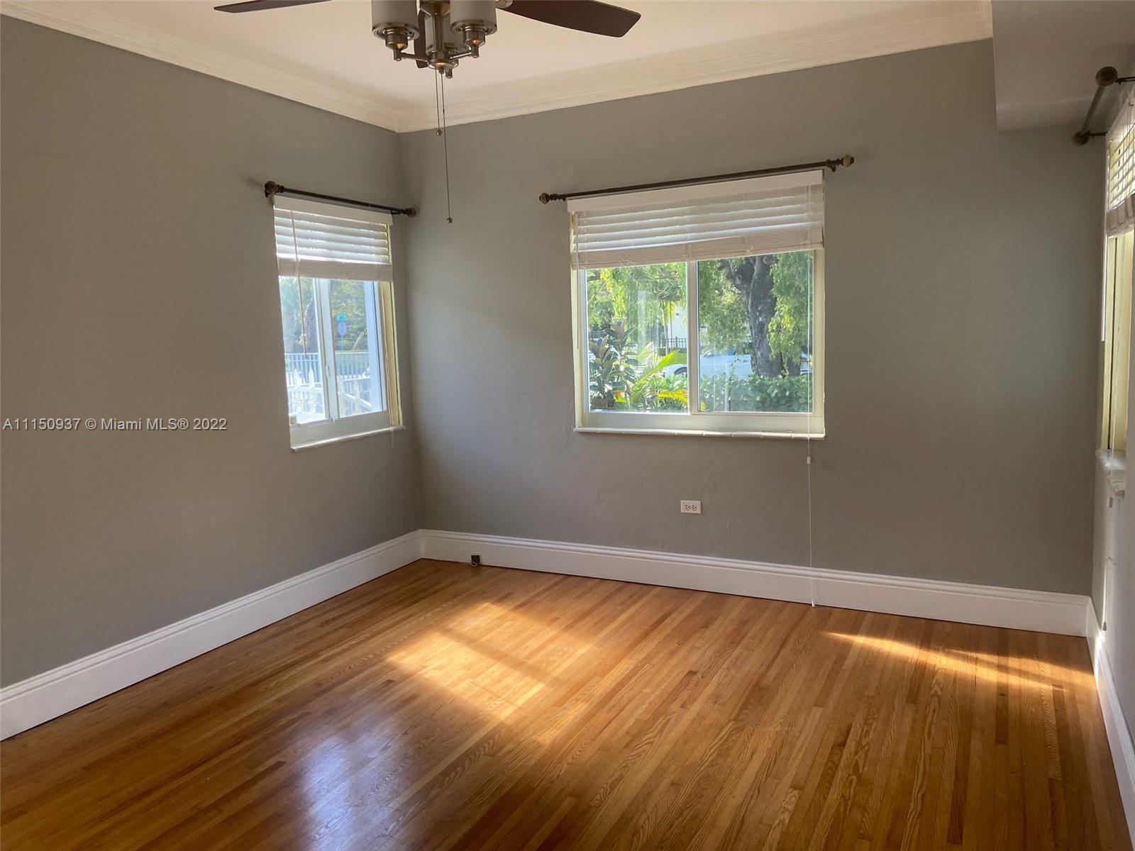 155 Southwest 28th Road Miami, FL 33129 - Photo 17 of 33 a view of an empty room with wooden floor and a window