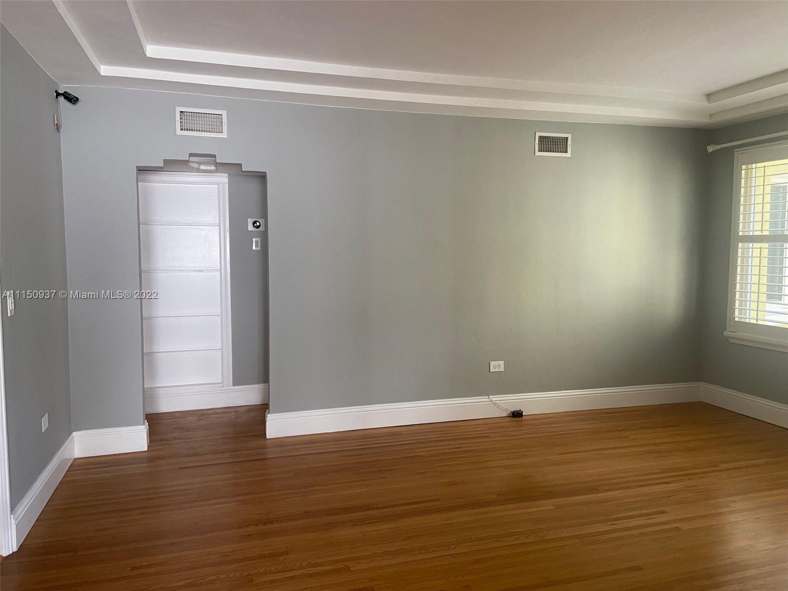 155 Southwest 28th Road Miami, FL 33129 - Photo 19 of 33 wooden floor in an empty room with a window