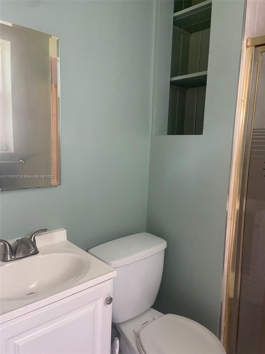 155 Southwest 28th Road Miami, FL 33129 - Photo 22 of 33 a white toilet sitting next to a bathroom sink