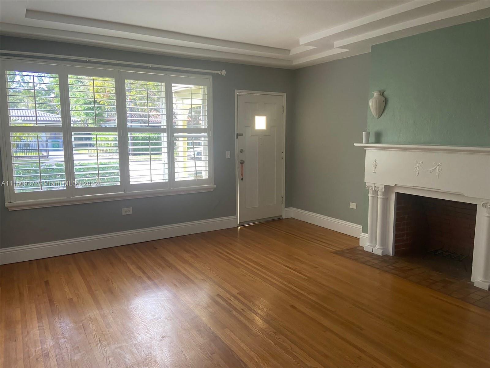 155 Southwest 28th Road Miami, FL 33129 - Photo 24 of 33 a view of an empty room with wooden floor and a window