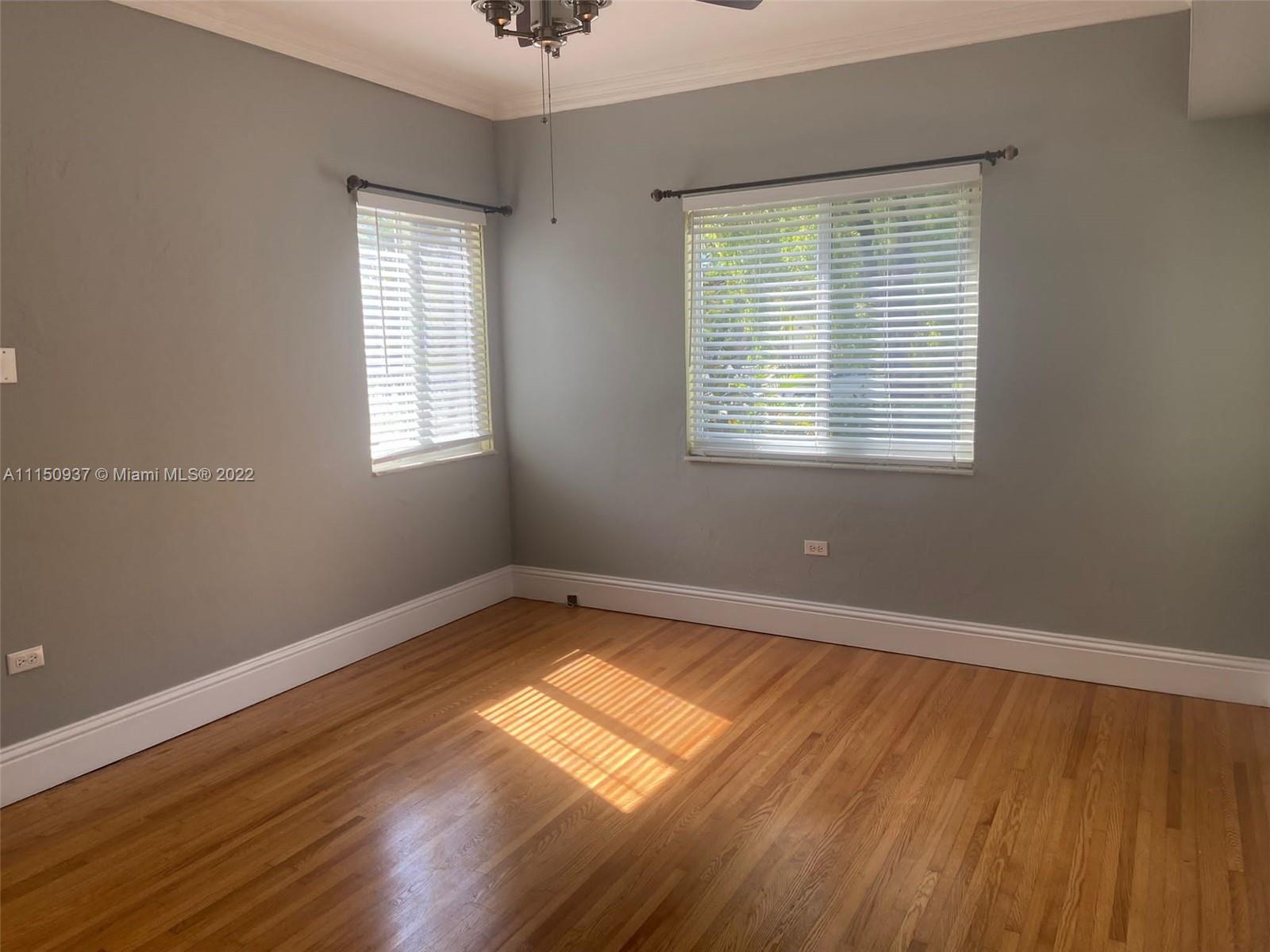 155 Southwest 28th Road Miami, FL 33129 - Photo 25 of 33 a view of an empty room with wooden floor and a window