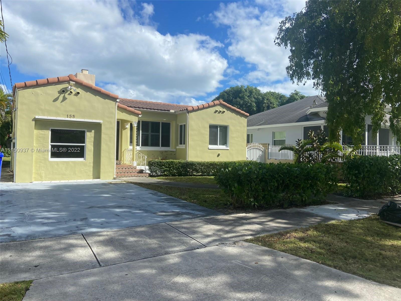 155 Southwest 28th Road Miami, FL 33129 - Photo 5 of 33 a front view of a house with a yard and garage