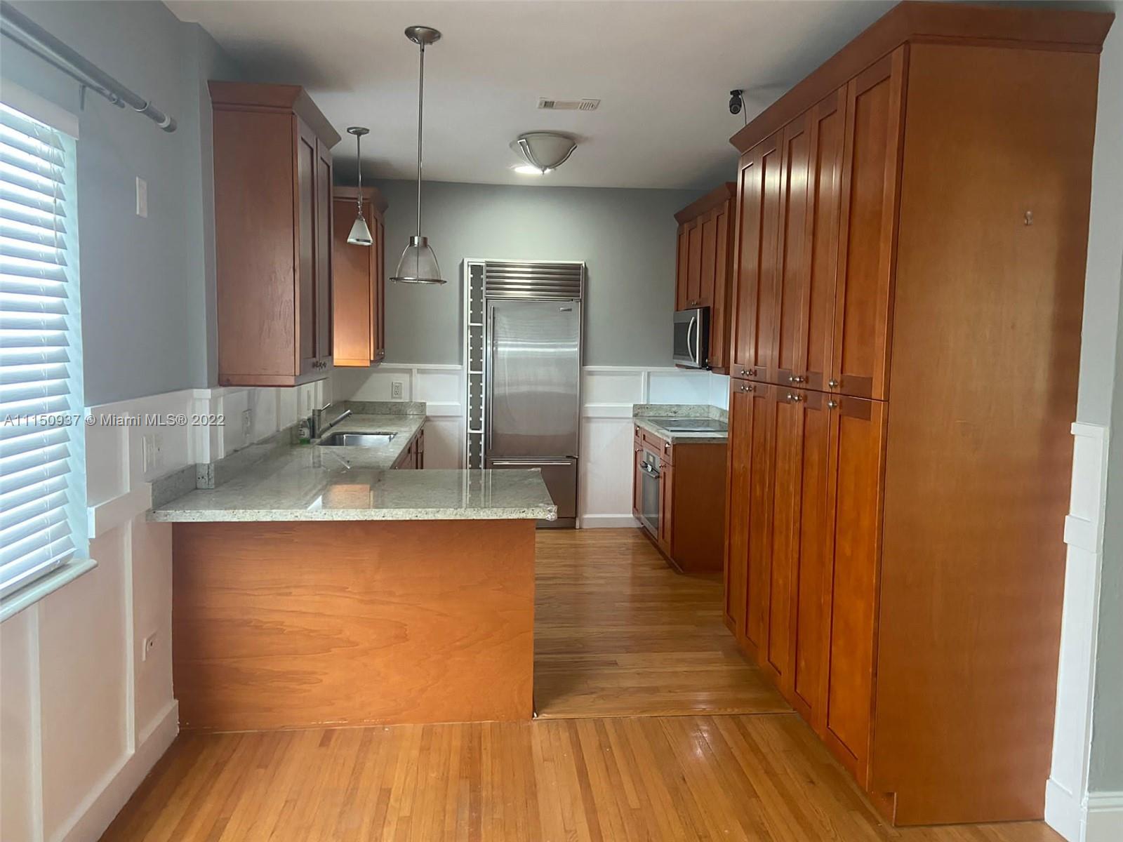 155 Southwest 28th Road Miami, FL 33129 - Photo 6 of 33 a view of a kitchen with wooden floor and staircase