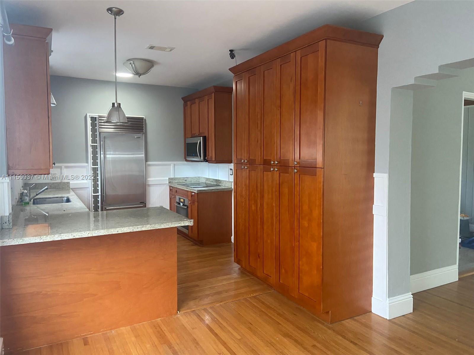 155 Southwest 28th Road Miami, FL 33129 - Photo 7 of 33 a kitchen with stainless steel appliances granite countertop a refrigerator and a sink