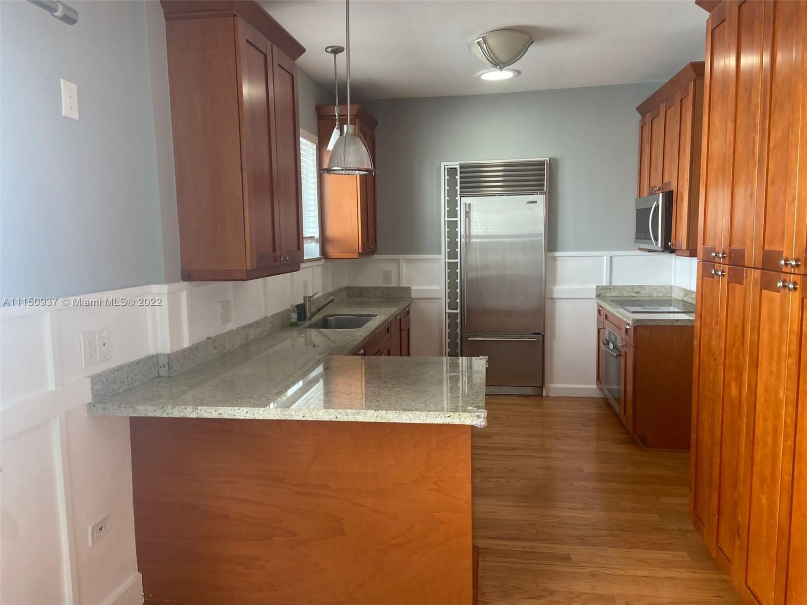 155 Southwest 28th Road Miami, FL 33129 - Photo 8 of 33 a kitchen with stainless steel appliances granite countertop a sink a stove and a refrigerator