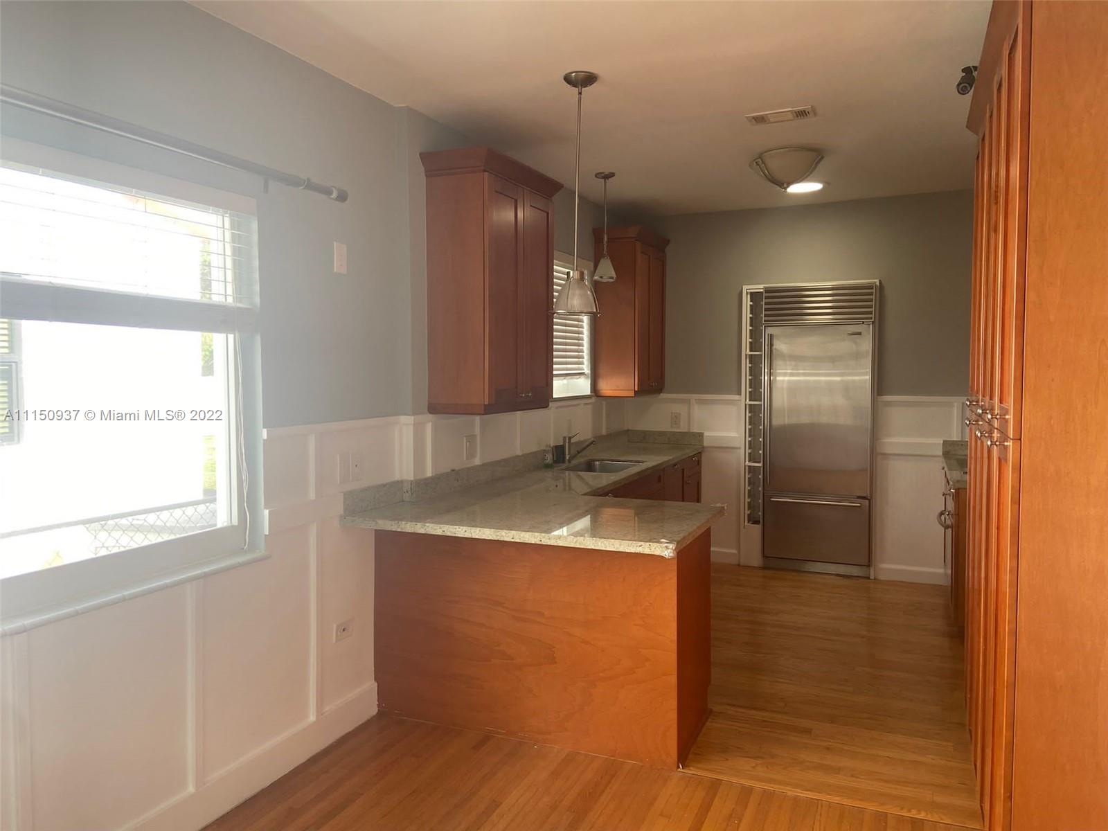 155 Southwest 28th Road Miami, FL 33129 - Photo 9 of 33 a kitchen with stainless steel appliances granite countertop a sink and a refrigerator
