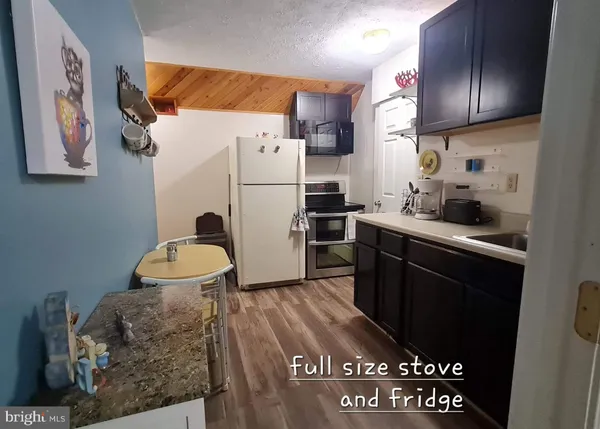a kitchen with stainless steel appliances a refrigerator and a stove