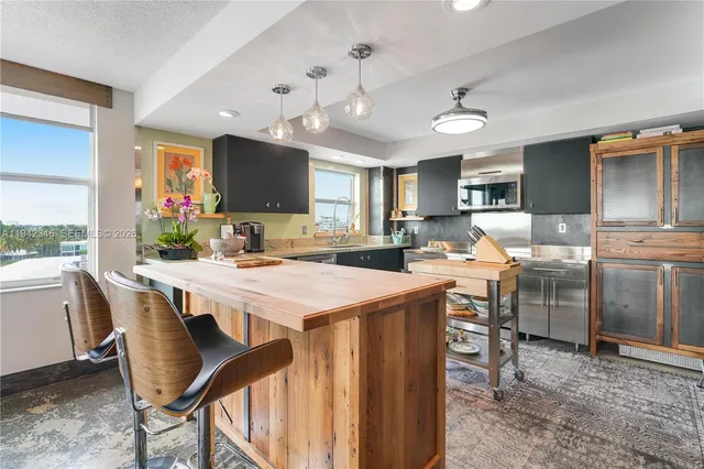 a large kitchen with a table and chairs