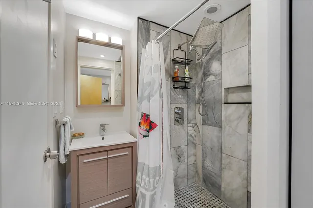 a bathroom with a shower and a sink