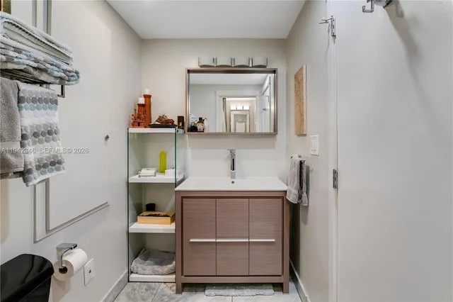 a bathroom with a sink a toilet and mirror