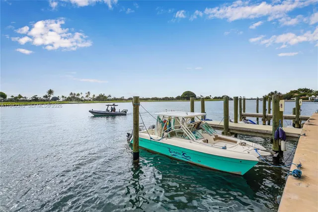 a view of a lake with tables and chairs