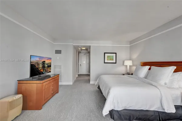 a bedroom with a bed and a chair