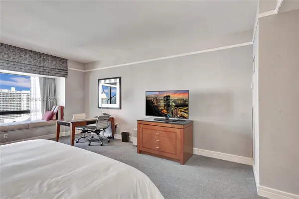 a bedroom with a bed and lamps