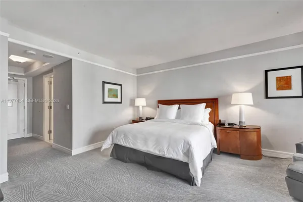 a bedroom with a bed and a lamp