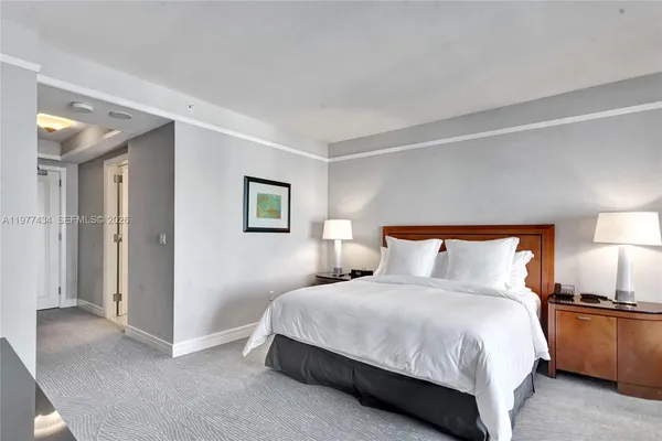 a bedroom with a bed and a television