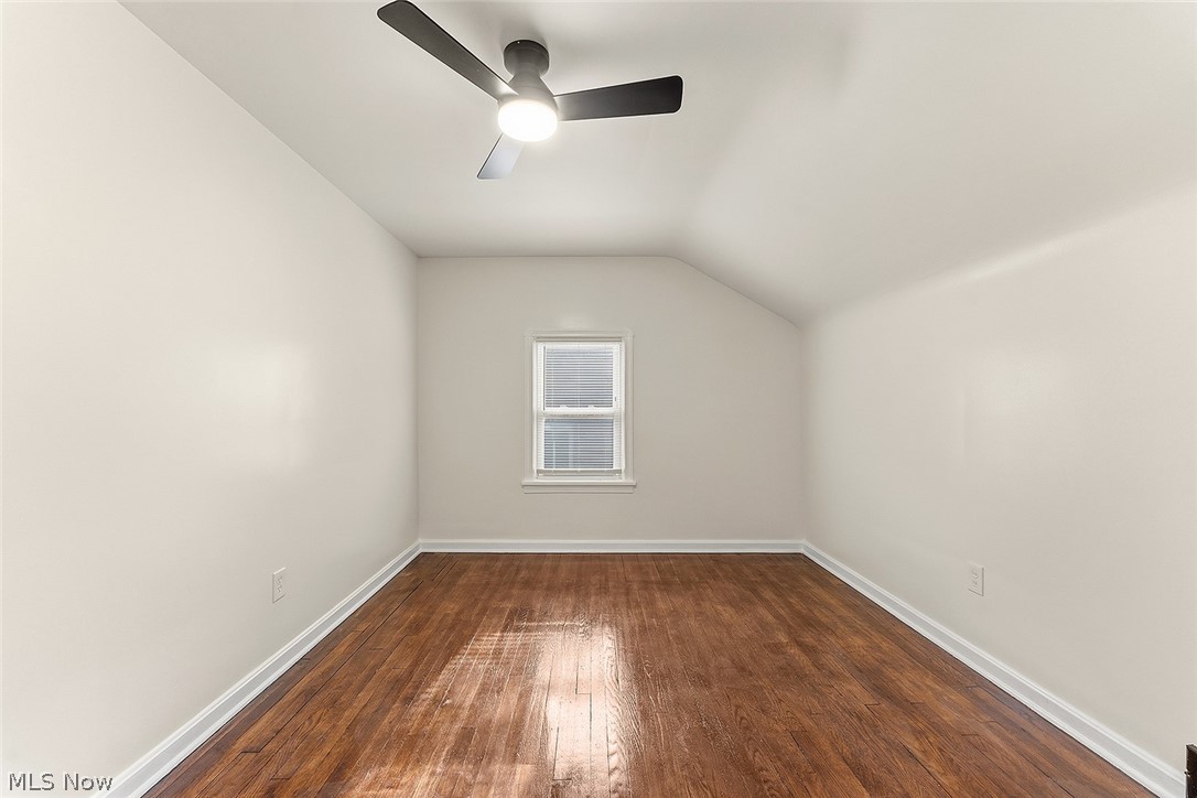 3791 Fairoaks Road South Euclid, OH 44121 - Photo 16 of 30 Room featuring wood-finish flooring, a window with horizontal blinds, sloped ceilings, a contemporary ceiling fan with integrated lighting, and white baseboards