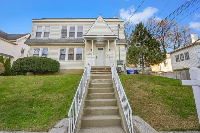 a front view of a house with a yard