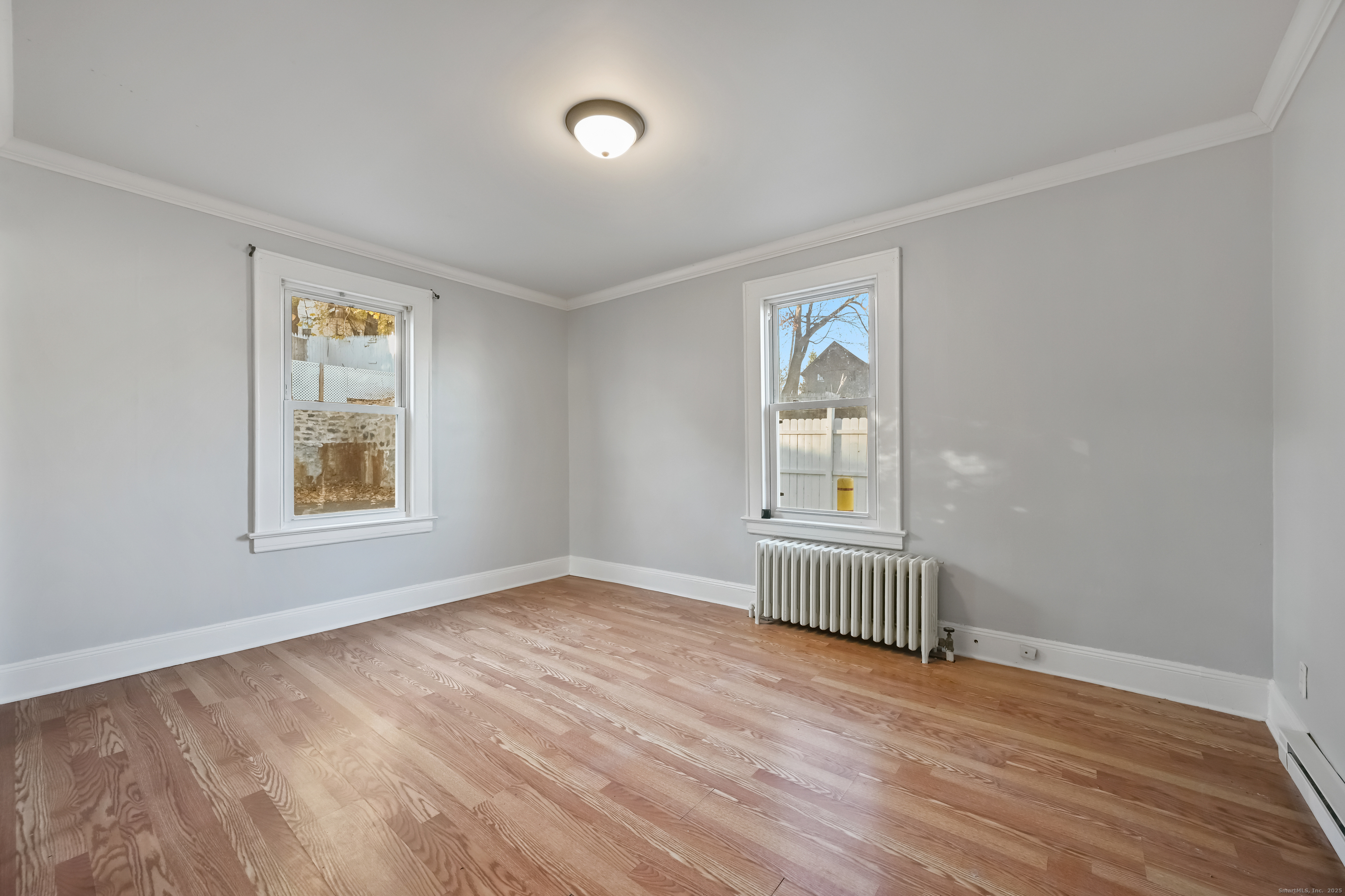 8 Smith Street, Unit 1 Danbury, CT 06810 - Photo 12 of 23 wooden floor in an empty room with a window