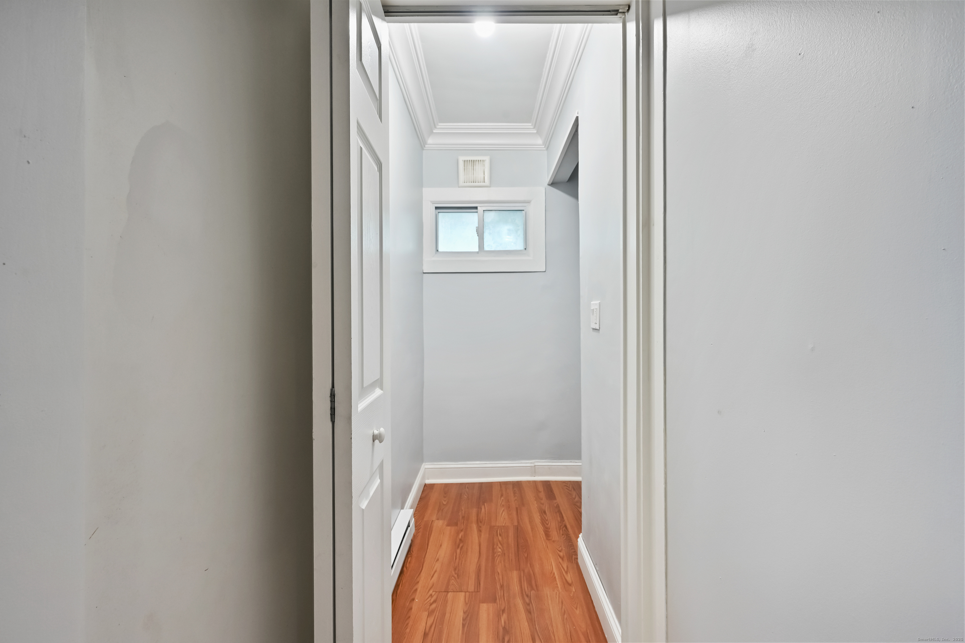 8 Smith Street, Unit 1 Danbury, CT 06810 - Photo 13 of 23 a view of a hallway with wooden floor and a window