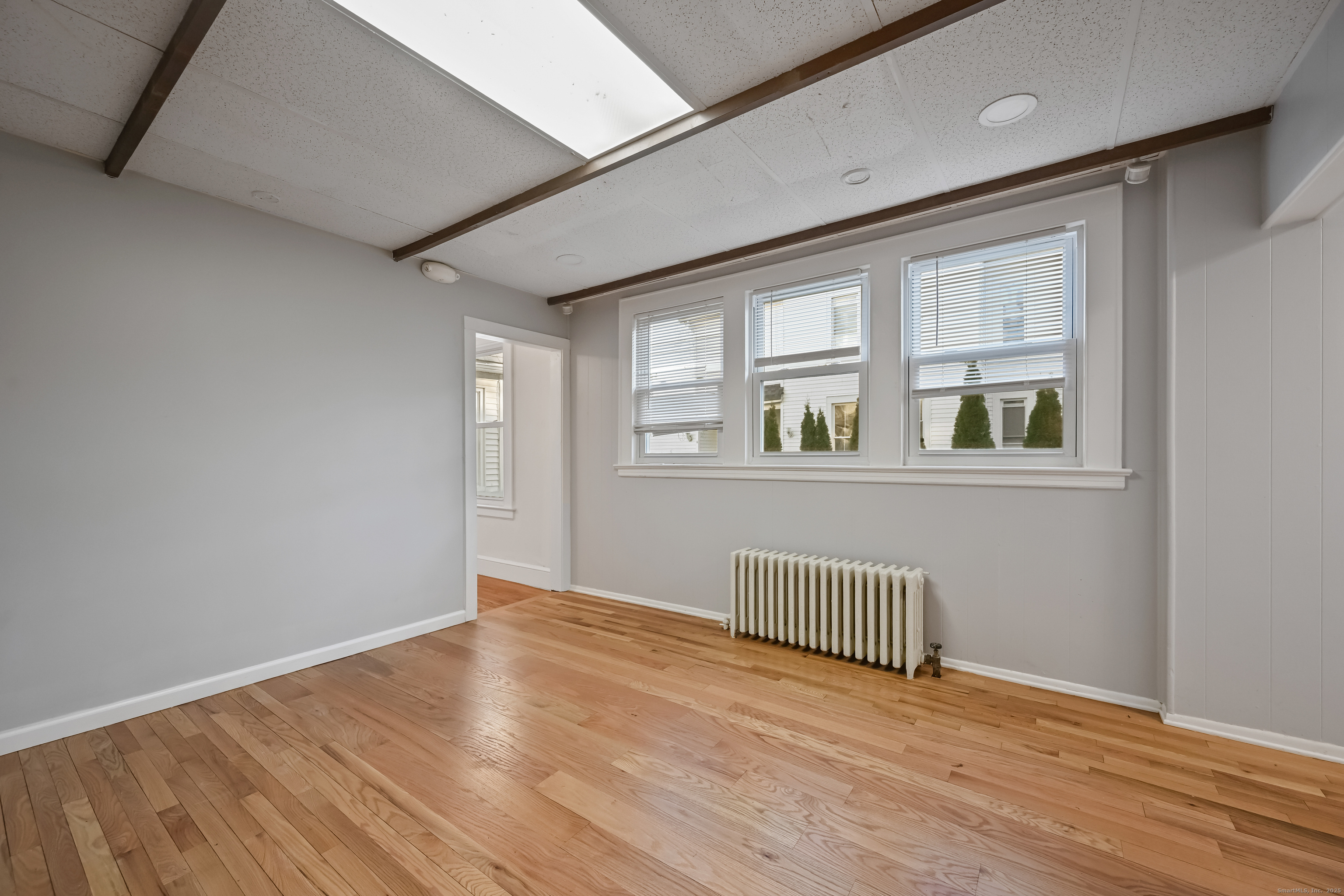 8 Smith Street, Unit 1 Danbury, CT 06810 - Photo 14 of 23 an empty room with wooden floor and windows
